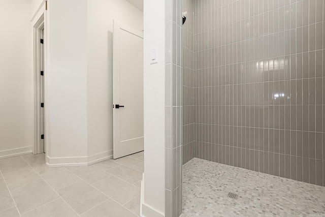 bathroom featuring tile patterned flooring and tiled shower