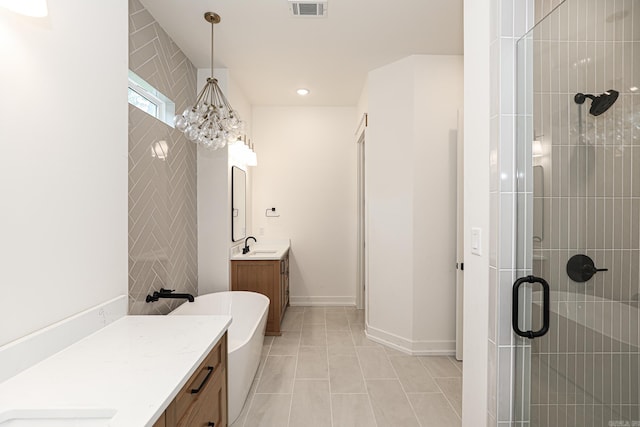 bathroom featuring separate shower and tub, tile patterned floors, vanity, and a chandelier