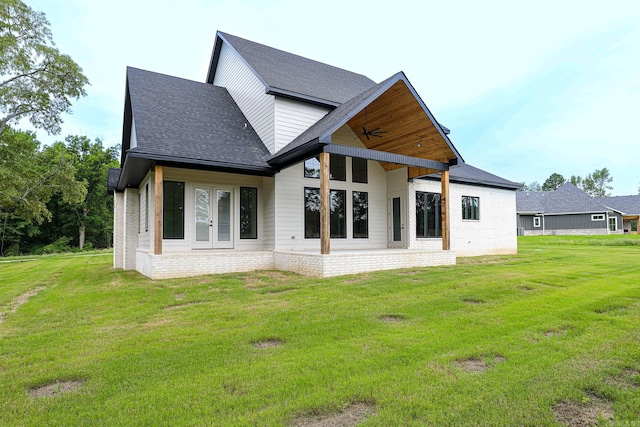 back of property featuring a lawn, ceiling fan, and french doors