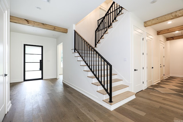 foyer entrance featuring beam ceiling and dark hardwood / wood-style floors