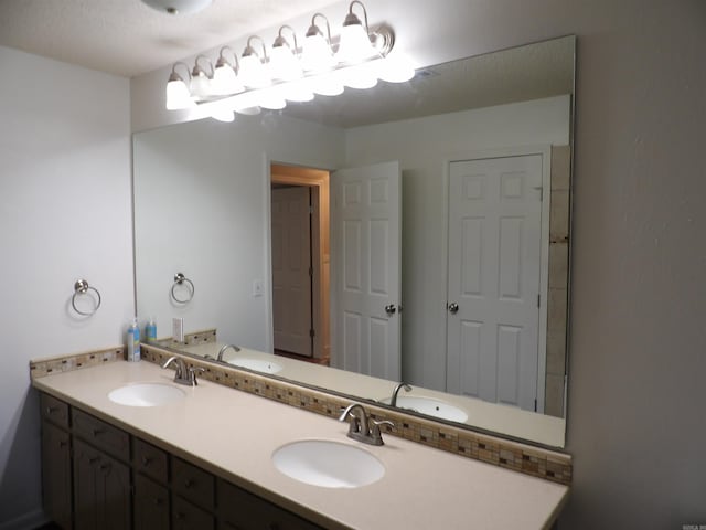 bathroom featuring vanity and a textured ceiling