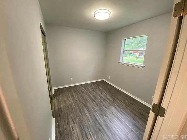 empty room with dark wood-type flooring