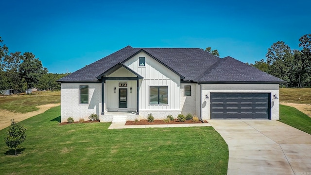 modern farmhouse style home with a front yard and a garage