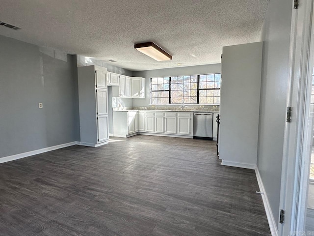 unfurnished living room featuring dark hardwood / wood-style flooring and a textured ceiling