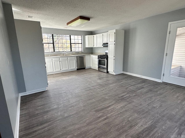 kitchen with sink, white cabinetry, dark wood-type flooring, and appliances with stainless steel finishes