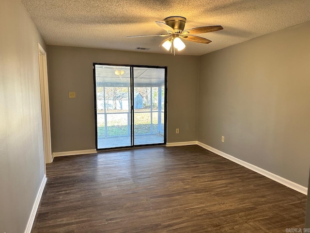 empty room with a textured ceiling, dark hardwood / wood-style flooring, and ceiling fan