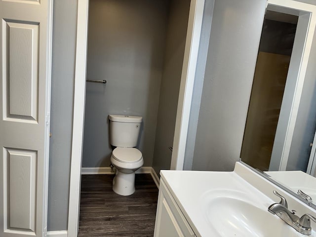 bathroom with vanity, wood-type flooring, and toilet