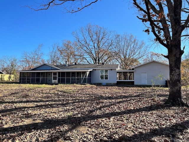 back of house featuring a sunroom