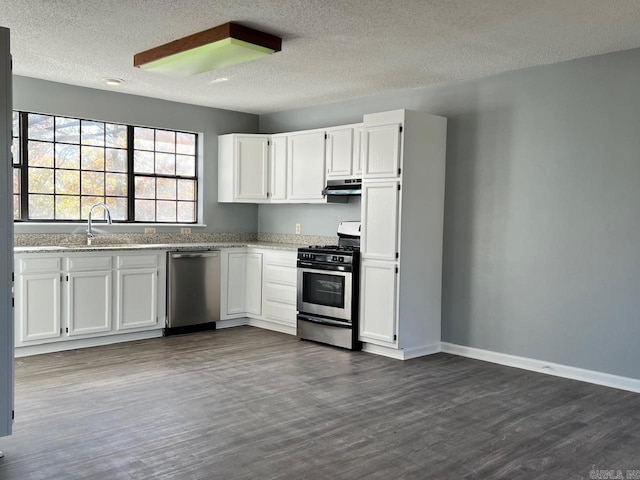 kitchen featuring a textured ceiling, white cabinetry, stainless steel appliances, and dark wood-type flooring