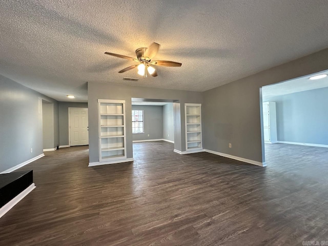 unfurnished living room featuring a textured ceiling, dark hardwood / wood-style flooring, ceiling fan, and built in shelves