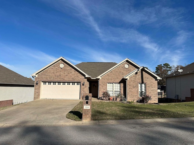 view of front of house with a front yard and a garage