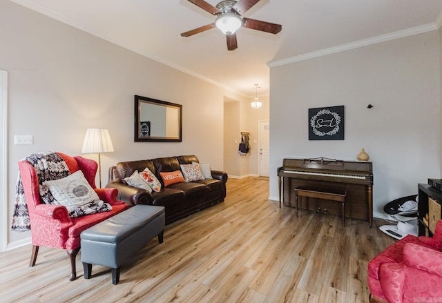 living room featuring ceiling fan, wood-type flooring, and crown molding