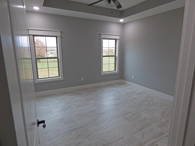 62 Highland Cove Dr, Highland, AR 72542 - unfurnished room featuring a ceiling fan, baseboards, recessed lighting, and a tray ceiling