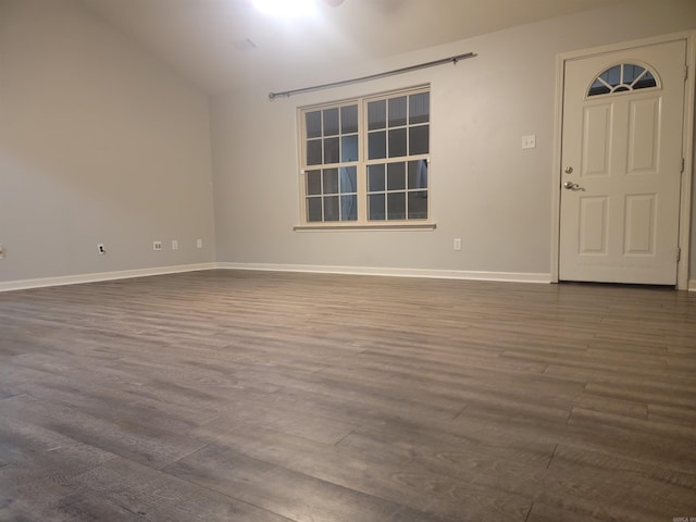 empty room featuring hardwood / wood-style flooring and lofted ceiling