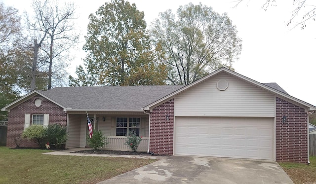 ranch-style home with covered porch, a garage, and a front lawn