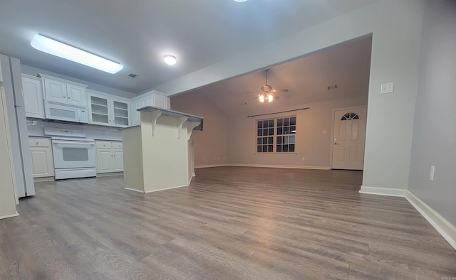 kitchen with white cabinets, decorative backsplash, light wood-type flooring, and white appliances