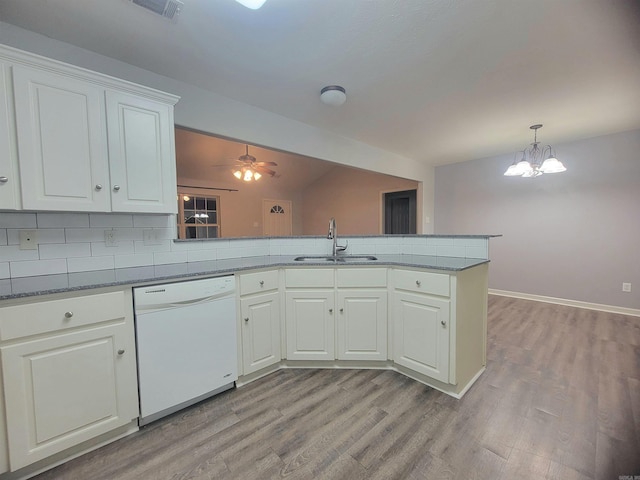 kitchen featuring dishwasher, sink, tasteful backsplash, light hardwood / wood-style flooring, and kitchen peninsula