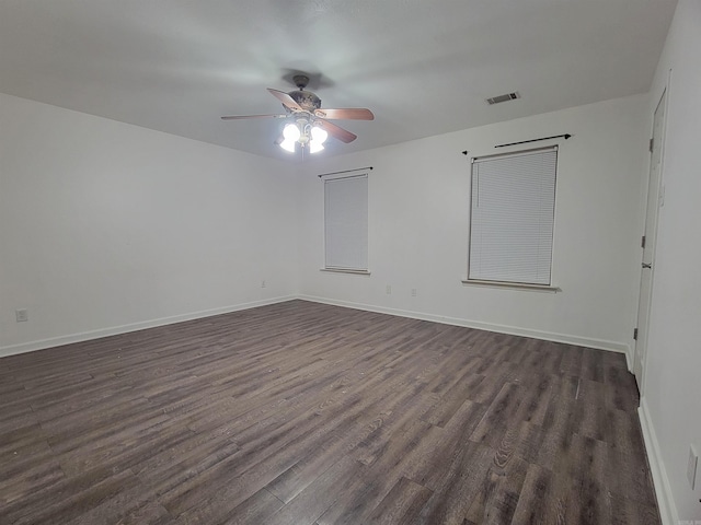 unfurnished room featuring ceiling fan and dark wood-type flooring