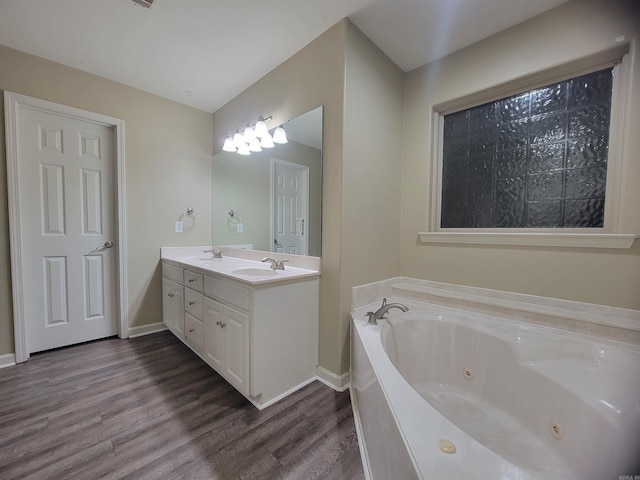 bathroom featuring a bath, vanity, and hardwood / wood-style flooring