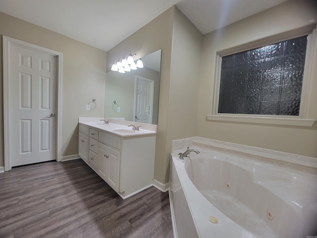 bathroom with a bathing tub, vanity, and hardwood / wood-style flooring