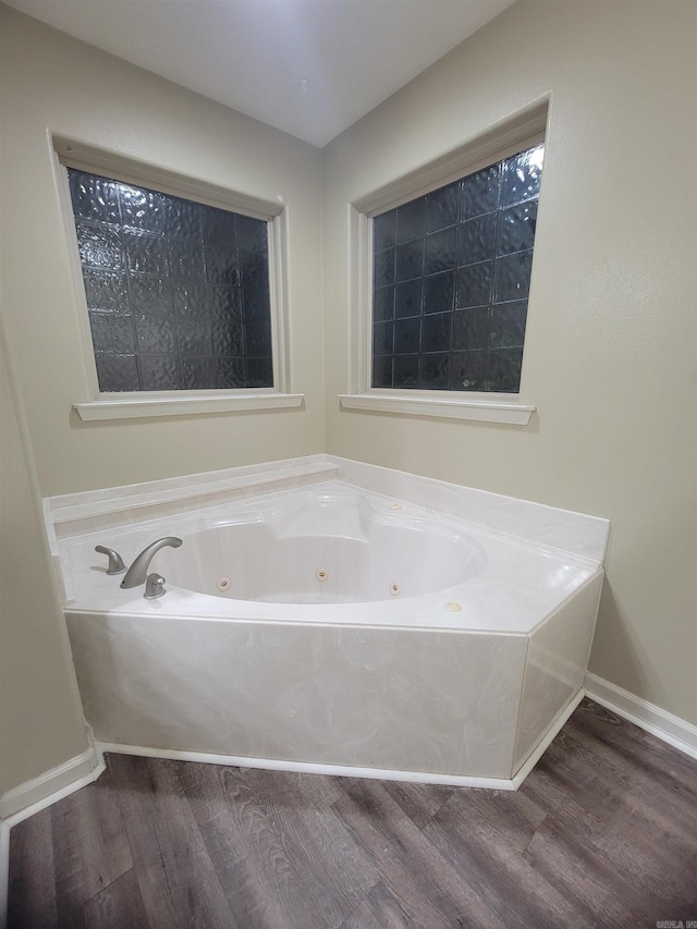 bathroom featuring a tub and wood-type flooring