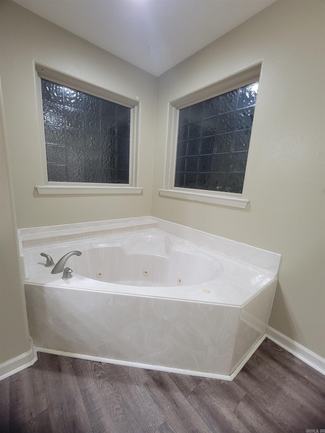 bathroom featuring wood-type flooring and a bathtub