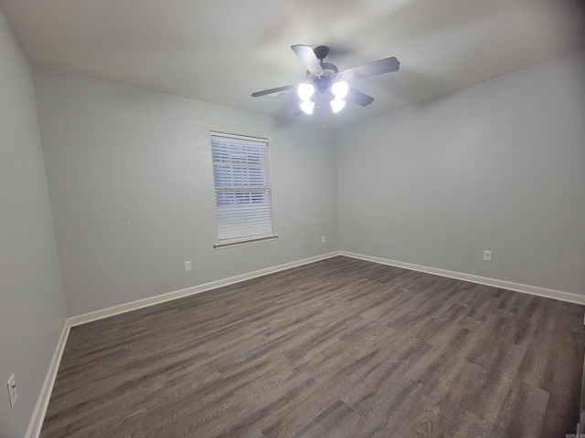 spare room with ceiling fan and dark hardwood / wood-style flooring