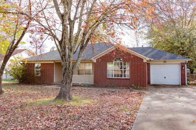 ranch-style home featuring a porch and a garage