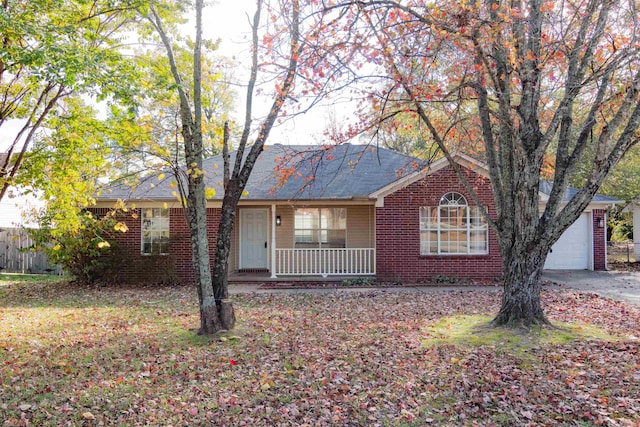 ranch-style house featuring covered porch and a garage