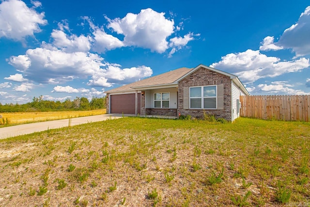 single story home featuring a front yard and a garage