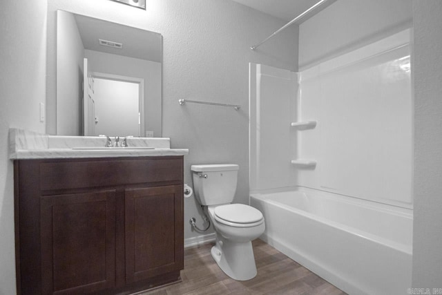 full bathroom with wood-type flooring, vanity, toilet, and shower / washtub combination