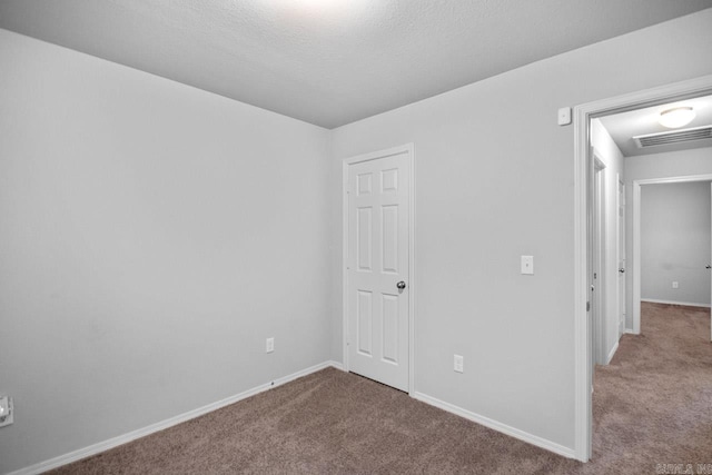 interior space featuring carpet and a textured ceiling