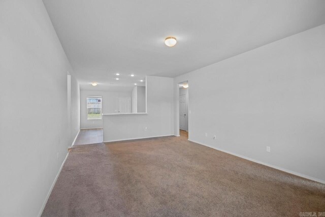 unfurnished room featuring carpet