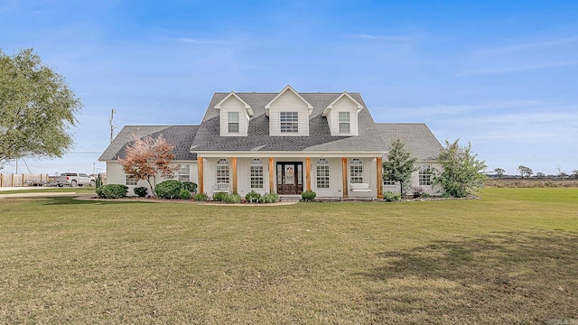 cape cod house with covered porch and a front yard