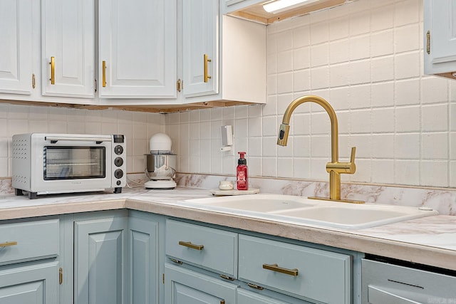 kitchen with white cabinetry and sink