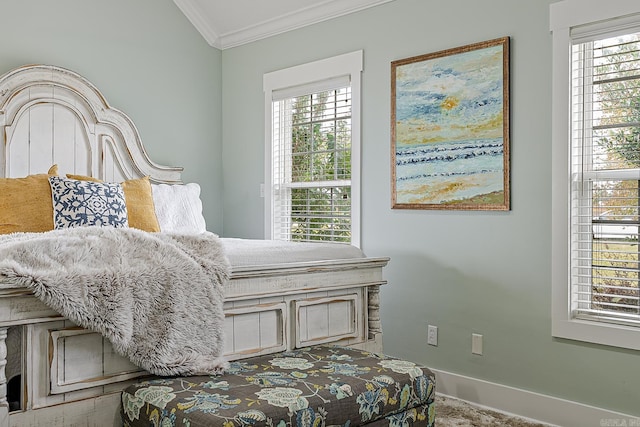 carpeted bedroom featuring multiple windows and ornamental molding