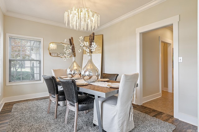 dining space featuring dark hardwood / wood-style flooring, ornamental molding, and a chandelier