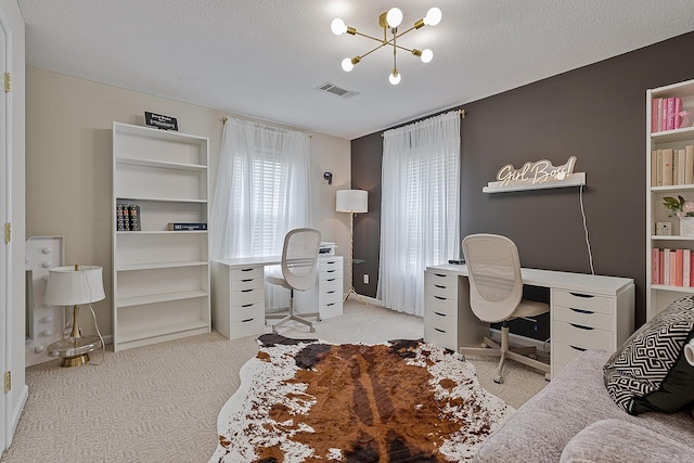 carpeted home office with a chandelier and a textured ceiling