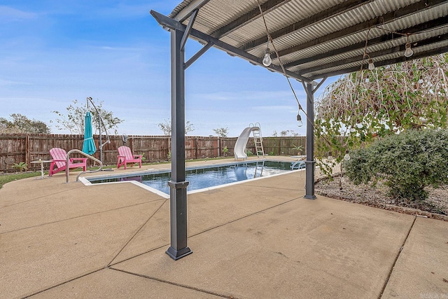 view of swimming pool featuring a patio area and a water slide