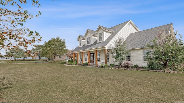 view of front of home with a porch and a front lawn