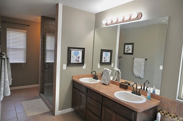 bathroom featuring tile patterned floors, vanity, and a shower with door