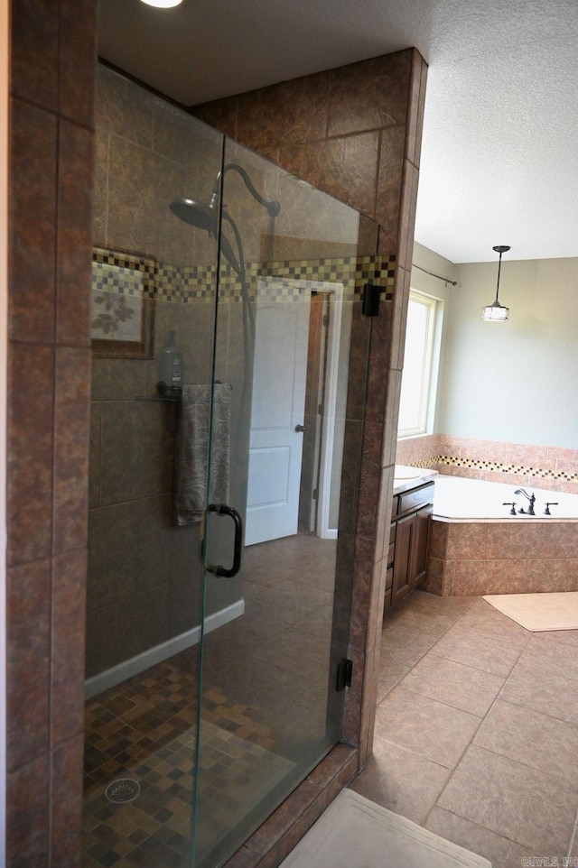 bathroom with tile patterned flooring, vanity, and plus walk in shower