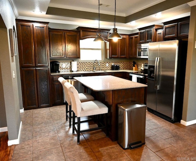 kitchen with dark brown cabinetry, a center island, sink, hanging light fixtures, and stainless steel appliances