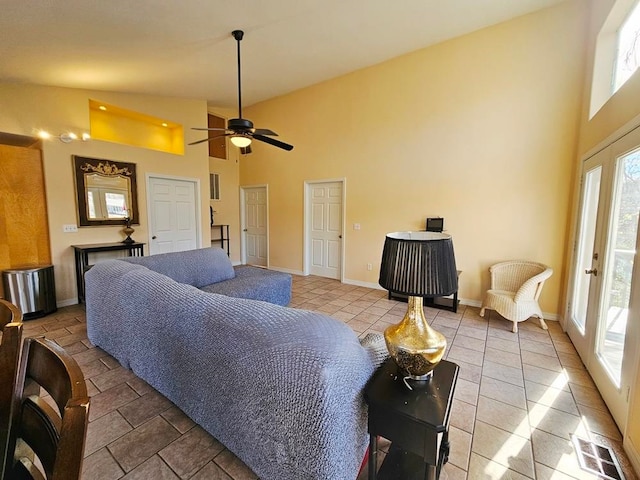 tiled living room featuring ceiling fan and high vaulted ceiling