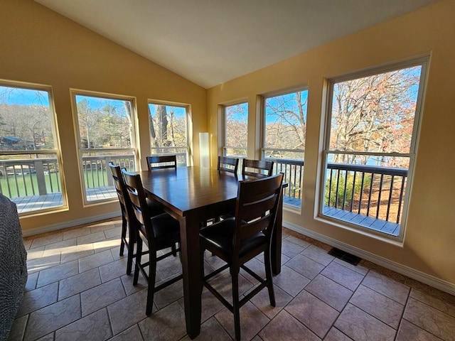 dining room with tile patterned floors and lofted ceiling