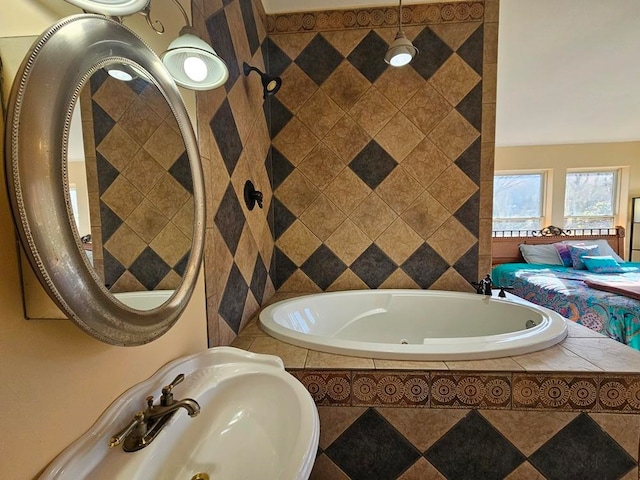 bathroom featuring sink and a relaxing tiled tub