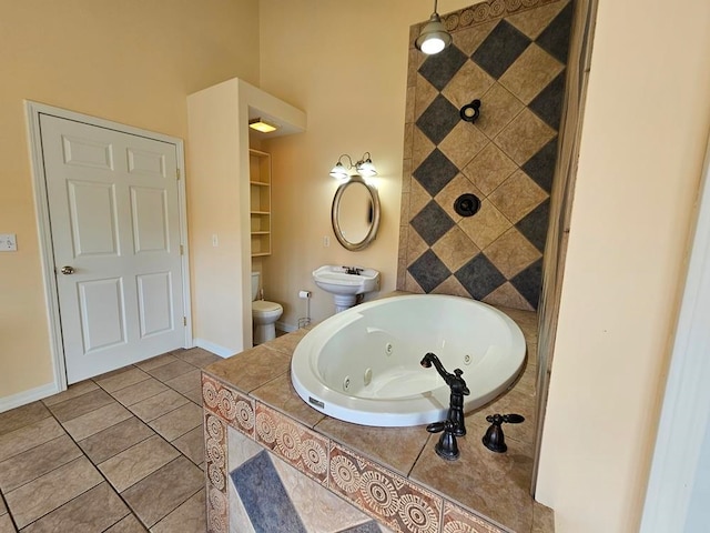 bathroom with toilet, tiled bath, and tile patterned floors