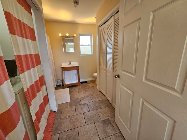 bathroom with tile patterned flooring, vanity, and toilet