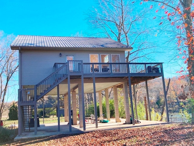 rear view of property featuring a patio and a deck