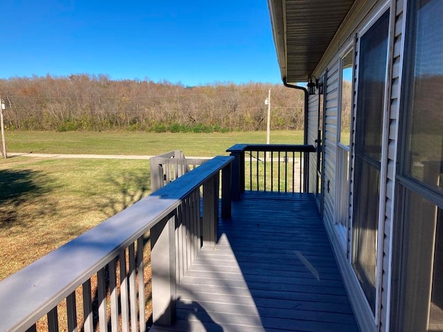 wooden deck featuring a yard